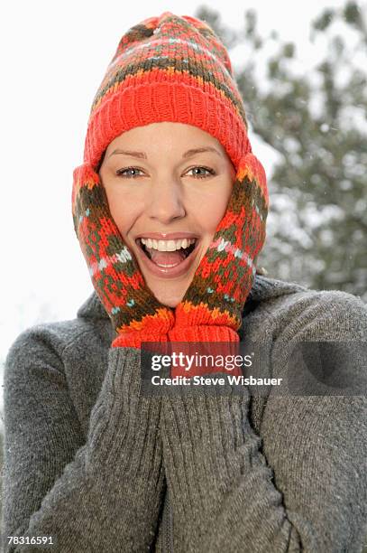 woman in winter clothes pressing hands to cheeks - face surprise heat stock pictures, royalty-free photos & images