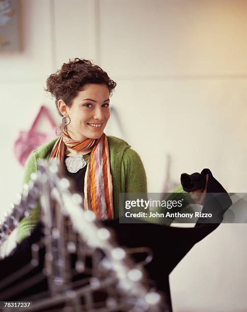 woman browsing clothing rack - clothes hanging on rack at store for sale foto e immagini stock