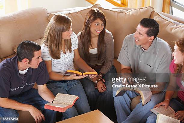 youth group with pastor in bible study - pastor stock pictures, royalty-free photos & images