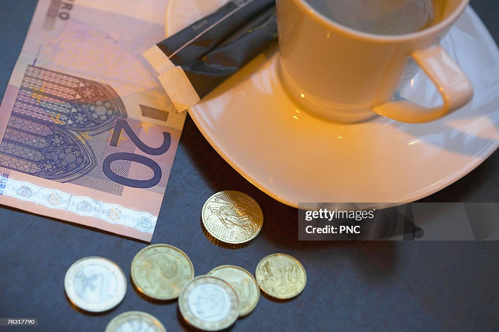 Coffee and money on table