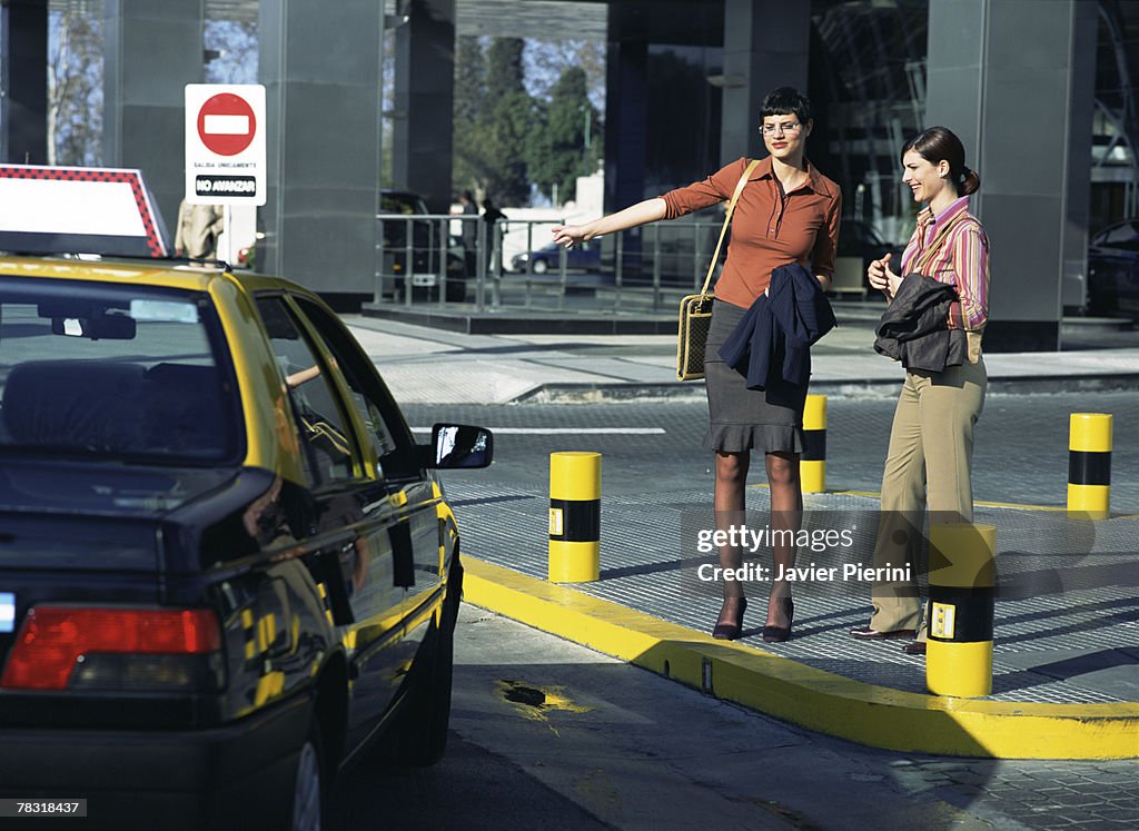 Women hailing taxicab