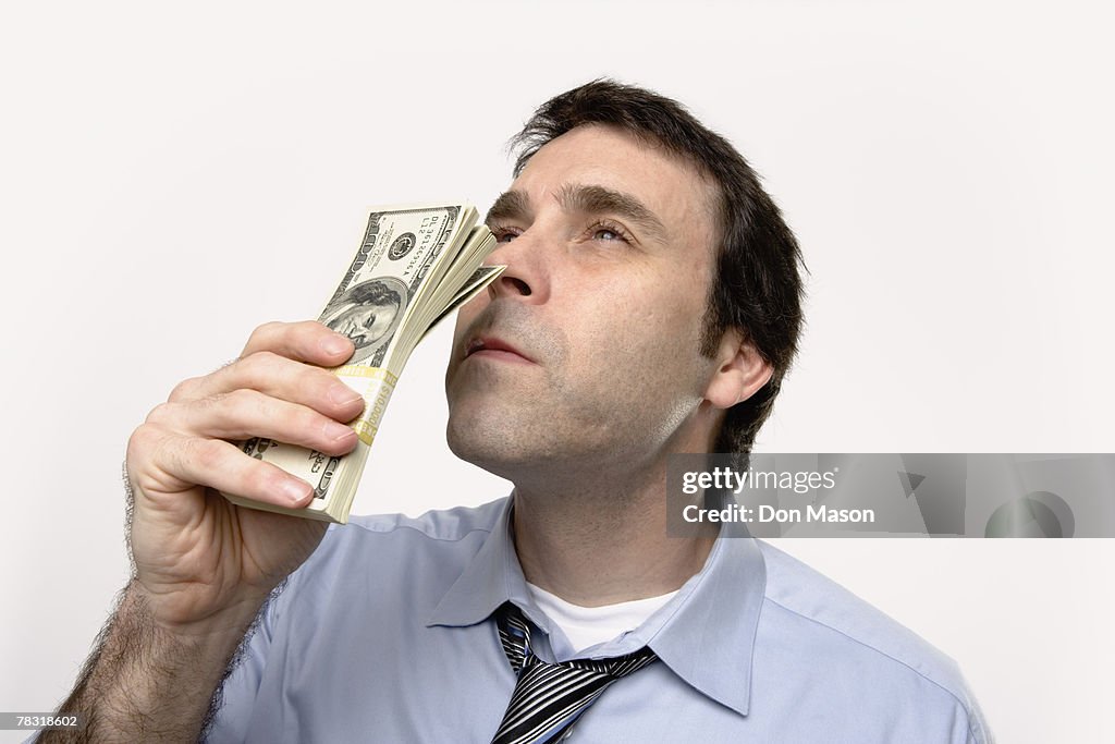 Man with stack of one hundred dollar bills