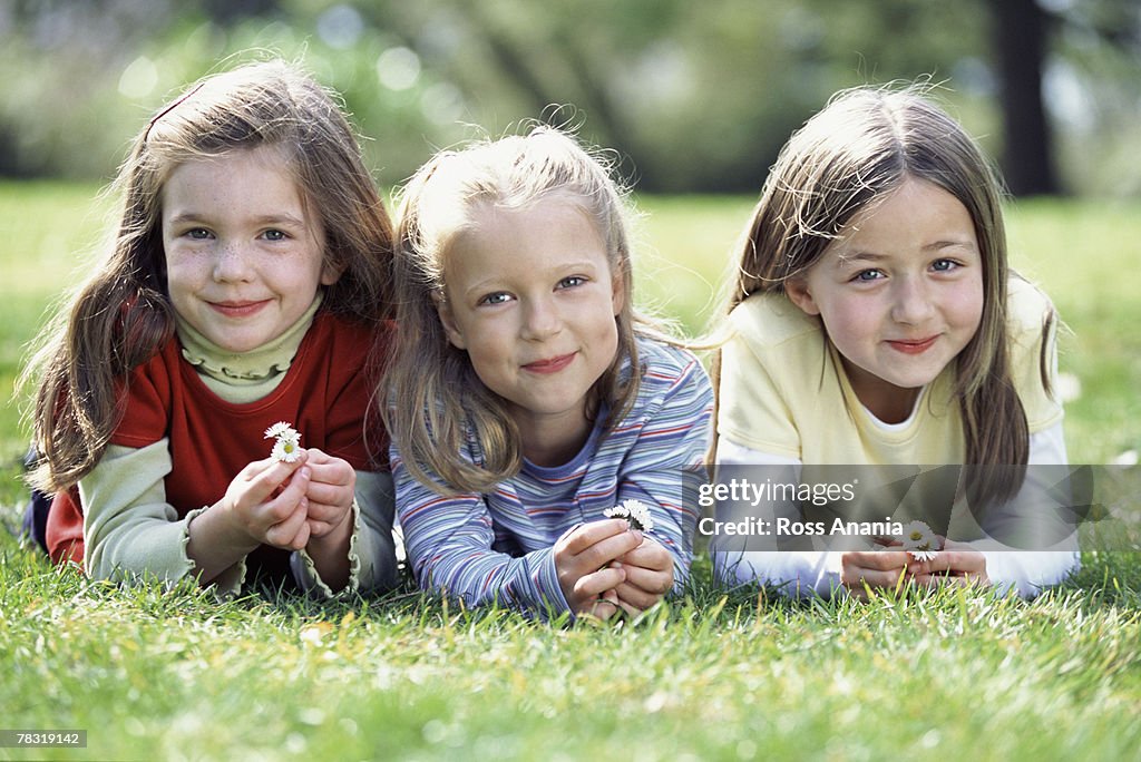 Girls relaxing on grass