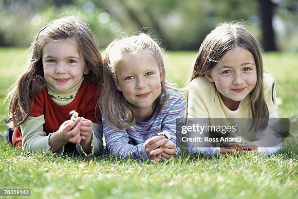 Girls Relaxing On Grass, Foto de stock