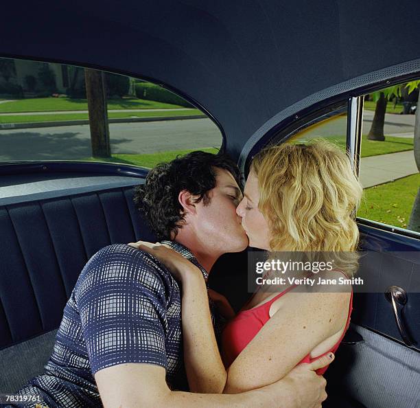 couple kissing in back seat of car - auto küssen stock-fotos und bilder