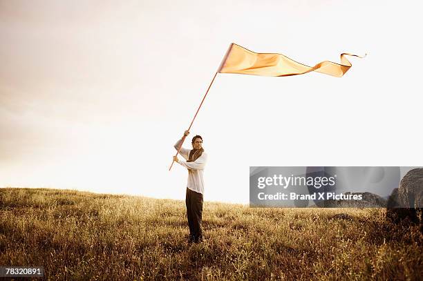 man with flag - holding flag stock pictures, royalty-free photos & images