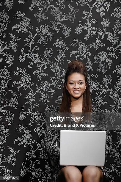 smiling woman using laptop computer - vrouw behangen stockfoto's en -beelden