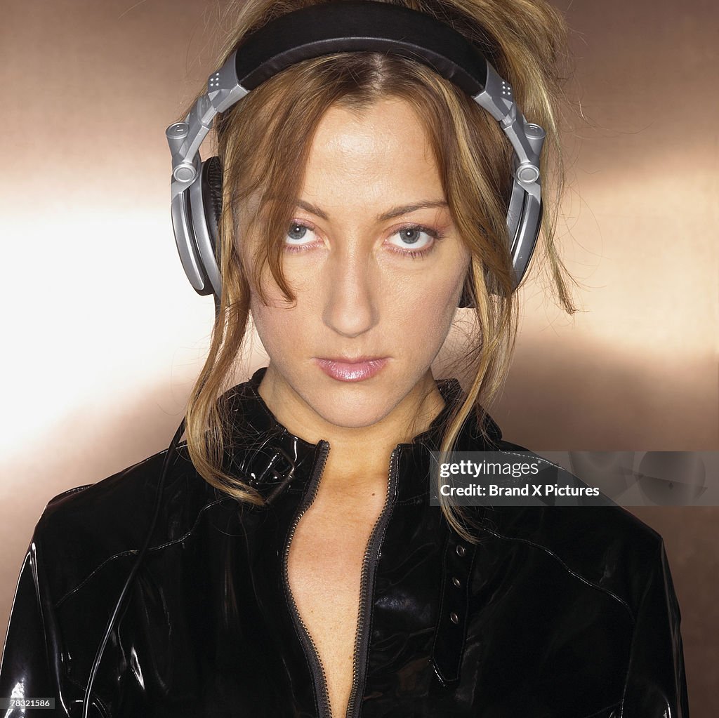Serious woman listening to music on headphones