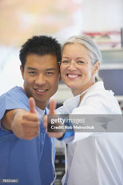 medical team giving thumbs up - rob sussman stockfoto's en -beelden