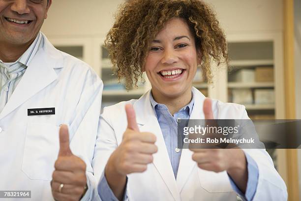 doctors making thumbs up gesture - rob sussman stockfoto's en -beelden