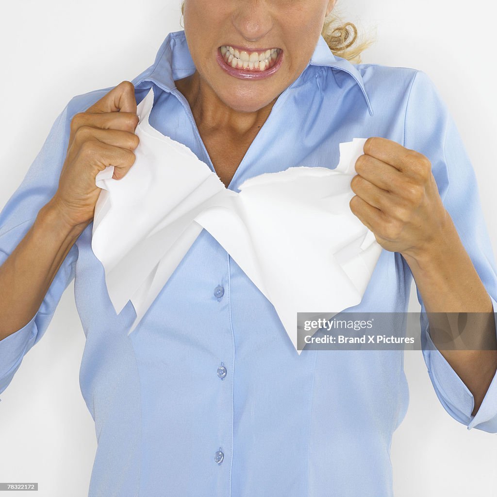 Angry woman tearing apart document