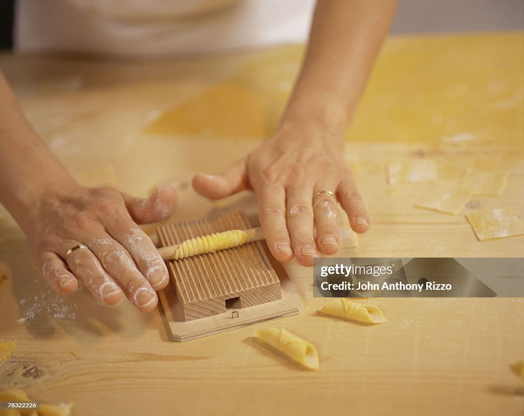 Man hand rolling pasta