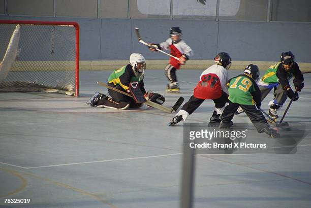 boys playing rollerhockey - ice hockey player stock pictures, royalty-free photos & images