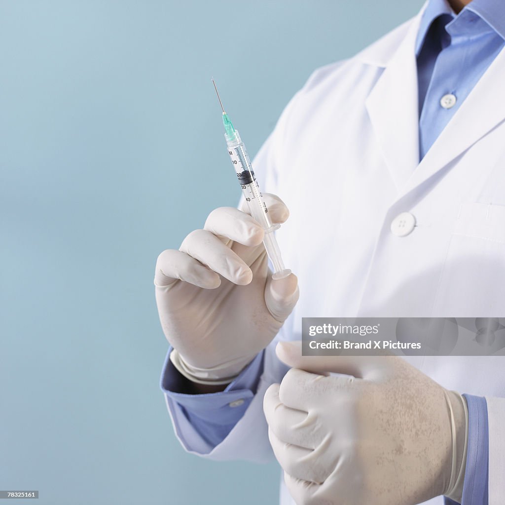 Hands of doctor with syringe