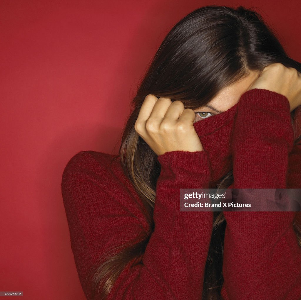 Woman hiding in her turtleneck sweater