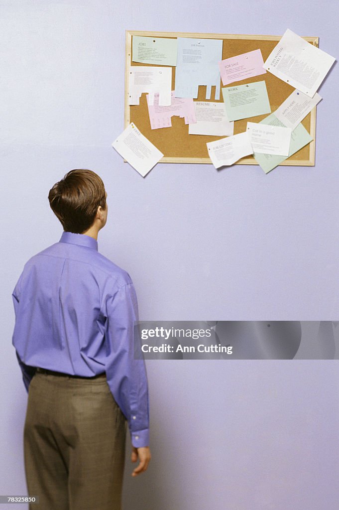 Businessman looking at noteboard