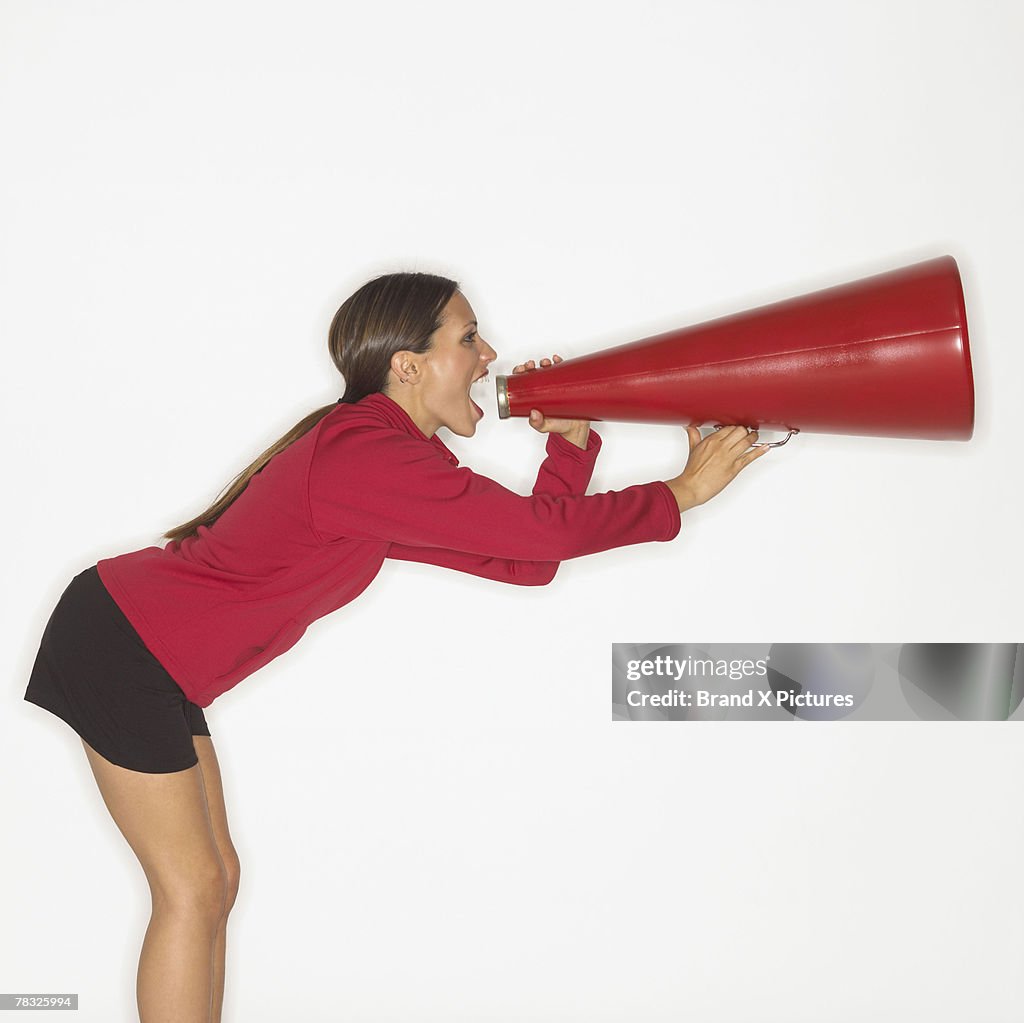 Woman screaming into bullhorn