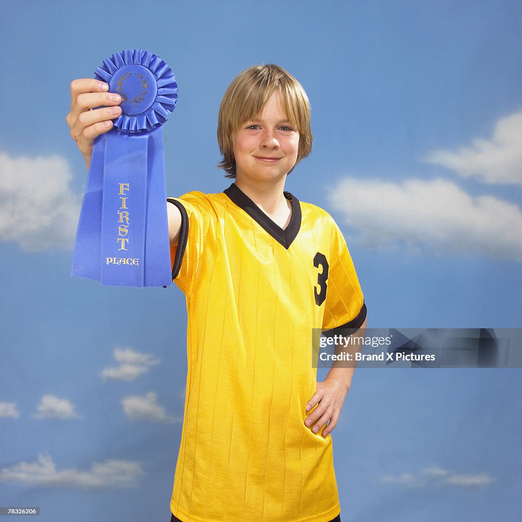 Boy holding blue ribbon