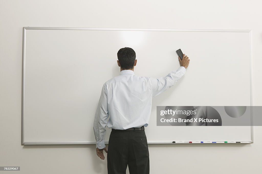 Man Erasing Notes Man Erasing White Board High-Res Stock Photo - Getty Images