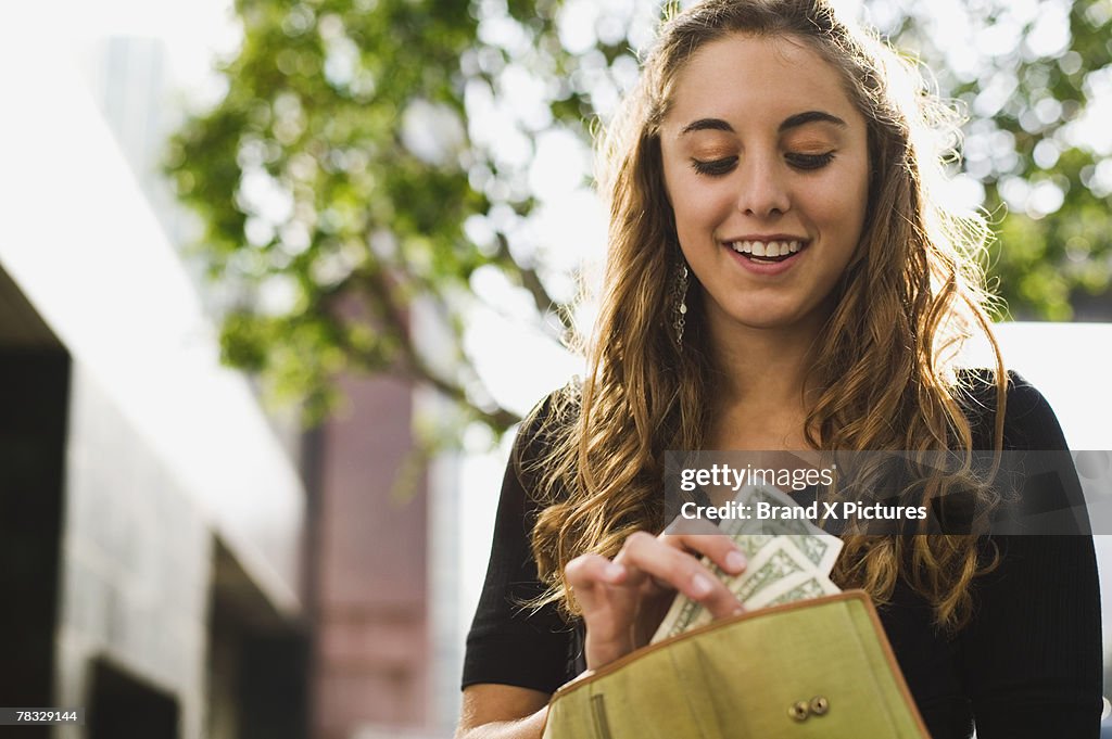 Teen removing money from wallet