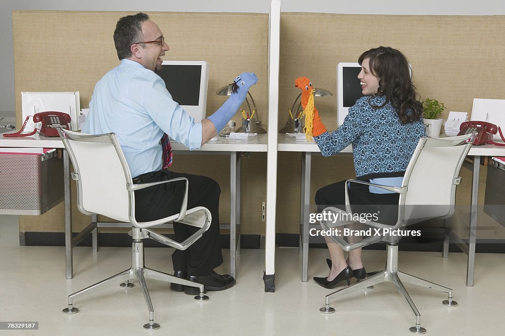 Coworkers playing with sock puppets