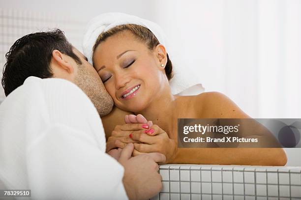 man kissing a woman on the cheek - couple and kiss and bathroom stock-fotos und bilder