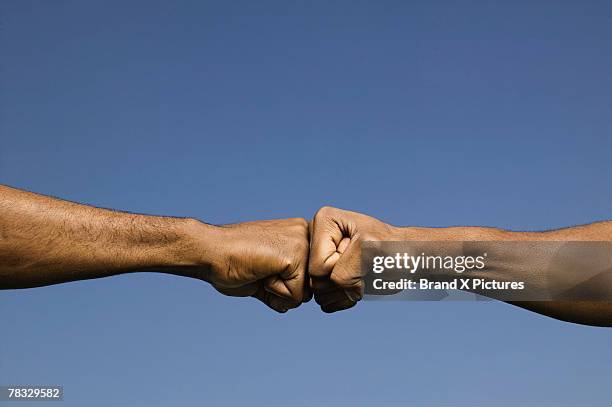 Bumping Two Fists Bumping Photos and Premium High Res Pictures - Getty Images