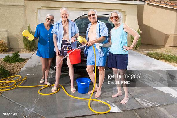 couples washing car - daily bucket foto e immagini stock