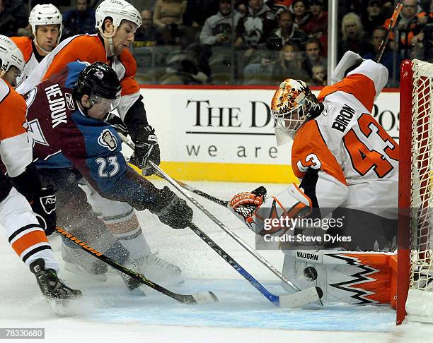 Milan Hejduk of the Colorado Avalanche puts a shot on goalie Martin Biron of the Philadelphia Flyers in the first period of the hockey game at the...