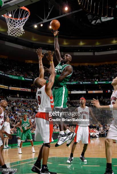 Kevin Garnett of the Boston Celtics takes a shot against Maceo Baston of the Toronto Rapters at the TD Banknorth Garden December 7, 2007 in Boston,...