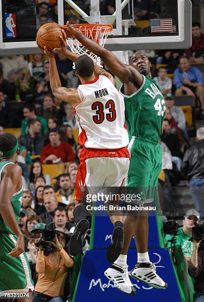 Kendrick Perkins of the Boston Celtics blocks Jamario Moon of the Toronto Rapters at the TD Banknorth Garden December 7, 2007 in Boston,...