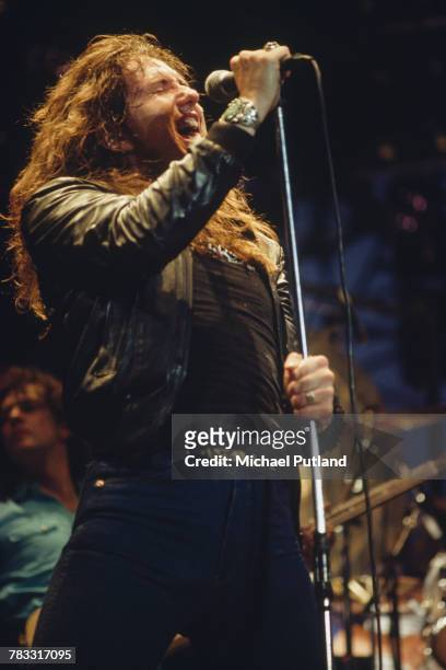 English singer David Coverdale performs live on stage with British heavy metal band Whitesnake at the Monsters of Rock festival at Donington Park,...