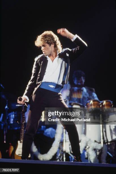 English singer-songwriter George Michael of Wham!, performing on stage during the pop duo's 1985 world tour, January 1985. 'The Big Tour' took in the...