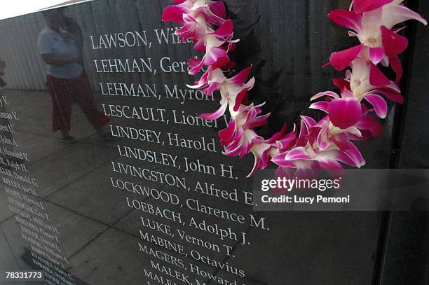 An orchid lei is drapped to the side of the new USS Oklahoma memorial during the commemoration marking the 66th anniversary of Pearl Harbor attack...