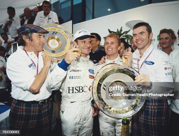 Former F1 Grand Prix World Champion Jackie Stewart and his son Paul , team principal for the Stewart Grand Prix team, celebrate winning the Formula...