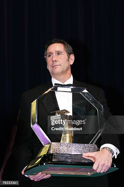 In this handout image provided by FIA, United States Grand Prix representative Tony George holds the Promoter Trophy during the 2007 FIA Gala Prize...