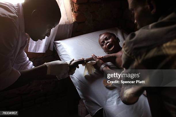 Bishara Ibraheim, 3-years-old, receives treatment for an infected and broken leg at a a clinic run by Doctors Without Borders December 8, 2007 in...