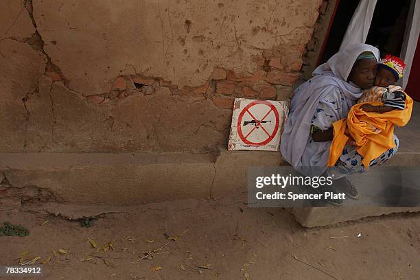 Woman and her daughter wait to see a doctor at a clinic run by Doctors Without Borders December 8, 2007 in Birao in northern Central African...