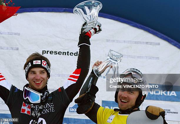 Austrian Manuel Veith and Sweden's Daniel Biveson celebrate on Men's parallel giant slalom snowboard World Cup podium in Limone Piemonte, 08 December...