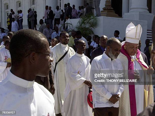 Haitian President Rene Preval , accompanied by Catholic priests, participates in a march 08 December 2007 to commemorate the 125th anniversary of the...