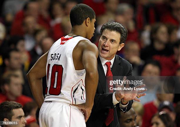 Rick Pitino, the Head Coach of the Louisville Cardinals, gives instructions to Edgar Sosa during the game against the Dayton Flyers at Freedom Hall...