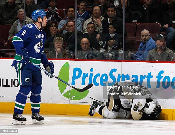 Willie Mitchell of the Vancouver Canucks yells at the referee as Sidney Crosby of the Pittsburgh Penguins lays injured on the ice after being high...