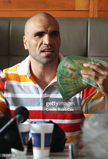 Anthony Mundine waves some cash around during the weigh in for his WBA Super Middleweight title fight with Jose Albero Clavero at the Boxa Bar on...