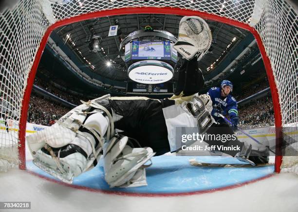 Dany Sabourin of the Pittsburgh Penguins makes a save off the shot of Brendan Morrison of the Vancouver Canucks during their game at General Motors...