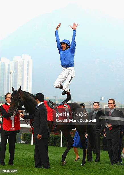 Jockey Frankie Dettori celebrates with a star jump from Ramonti after winning the Cathay Pacific Hong Kong Cup during the Cathay Pacific Hong Kong...