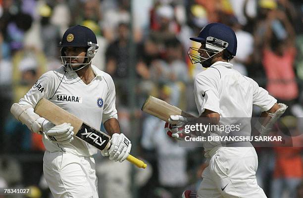 Indian cricketers Irfan Pathan and Sourav Ganguly complete a run during the second day of the third Test between India and Pakistan at the...