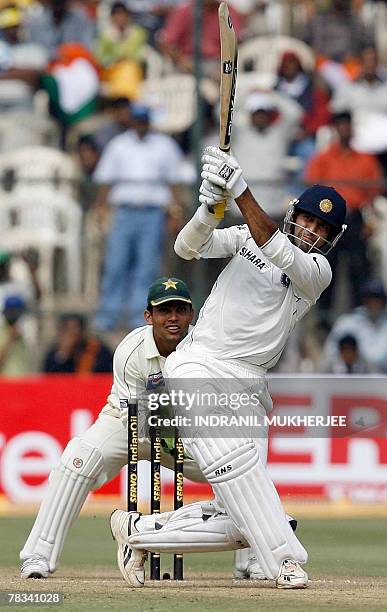 Pakistani cricketer Kamran Akmal looks on as Indian cricketer Irfan Pathan plays a shot on the second day of the third Test between India and...