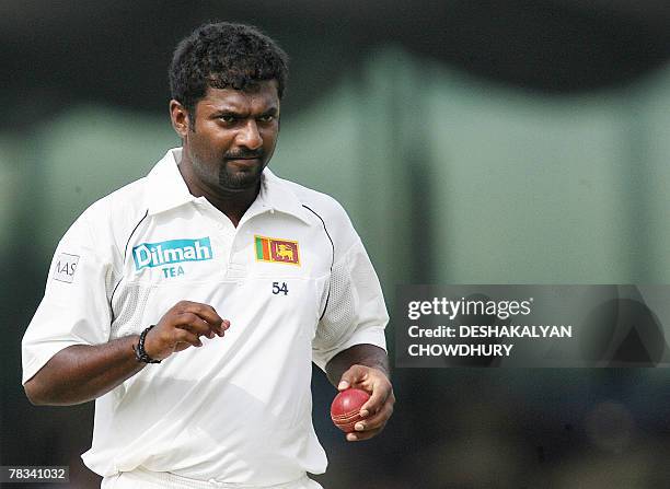 Sri Lankan bowler Muttiah Muralitharan prepares to deliver a ball to England batsman Alastair Cook during the second Test match at Sinhalese Sports...