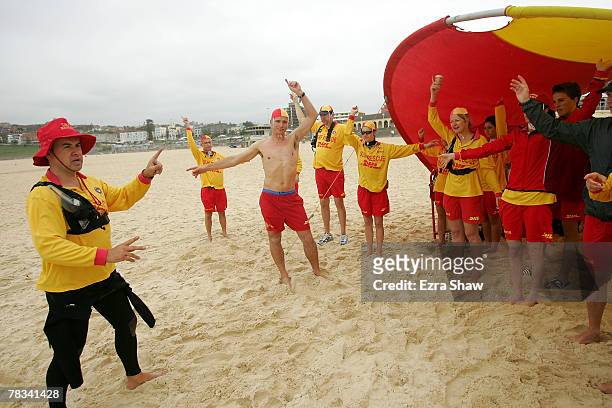 Mark Travers, a volunteer lifesaver, reviews all the hand signals with the rest of the patrol at Bondi Beach on December 8, 2007 in Sydney,...