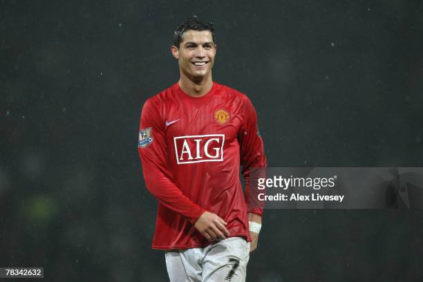 Cristiano Ronaldo of Manchester United smiles as the rain pours during the Barclays Premier League match between Manchester United and Derby County...